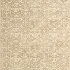 a beige rug with an intricate design on it