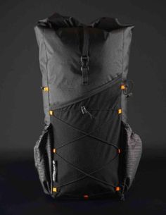 the back side of a black backpack with orange lights on it, against a dark background