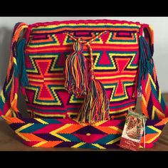 Handcrafted By Indigenous From The Guajira Colombiana, Each Bag Is Unique And The Time To Elaborated Is Between 20 To 30 Days. Pink Backpack For Vacation, Multicolor Rectangular Backpack For Festivals, Multicolor Rectangular Festival Backpack, Festival Rectangular Multicolor Backpack, Pink Casual Bags For Festival, Casual Pink Bag For Festivals, Casual Pink Festival Bag, Purple Bucket Bag Tote For Travel, Purple Tote Bucket Bag For Travel