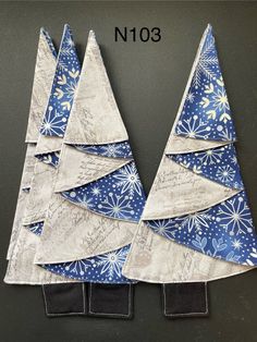 three small christmas trees made out of fabric