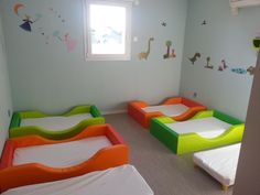 there are many beds in the children's room with no mattresses on them