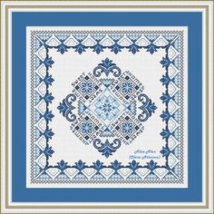 a blue and white cross stitch pattern with an ornate design in the center, on top of