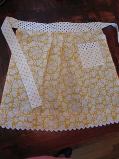 the apron is made out of yellow and white fabric