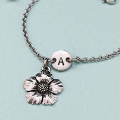 Flower charm bracelet with hand stamped initial. Bracelet size is 6 1/2 inches with 2 inch extender. If you need a larger size please message me. *Initial charm is antique silver pewter 9mm *Flower charm is antique silver pewter *Your purchase will arrive packaged in a cute gift box and I will include a message by request. Add on a birthstone charm for $3.00 https://www.etsy.com/listing/235600956 *Go back to Toodaughters https://www.etsy.com/shop/Toodaughters Personalized Silver Flower Bracelets, Personalized Silver Flower Bracelet, Silver Personalized Flower Bracelet, Flower Charm Bracelet, Bracelet Flower, Bracelet Initial, Personalized Bracelet, Cute Gift Boxes, Initial Bracelet