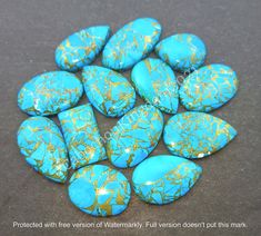 several turquoise and gold colored rocks on a black surface with the words, protected with free version of watermark full version doesn't