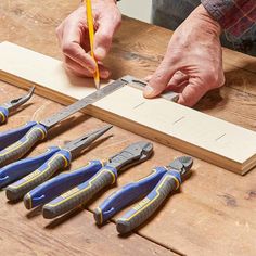 a man working with tools on a wooden table