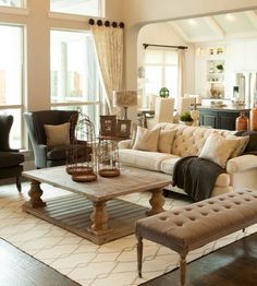 a living room filled with furniture and lots of windows