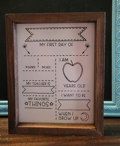 a wooden frame with an arrow and some writing on the inside that says, my first day of school