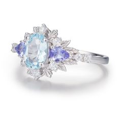 With every glance at our Dahlia Aquamarine Tanzanite Ring, may you be reminded of the extraordinary love that blossoms between you. This work of art showcases an oval aquamarine embraced by tanzanite gemstones on each side and surrounded by intricate leafy patterns, adding a whimsical and elegant touch. Let your love story unfold like the petals of a dahlia, revealing its timeless beauty. ✦ Available in both 14K white gold vermeil (14K white gold plated over a sterling silver base) and 10K solid Gold Vermeil Jewelry, Ring White Gold, Tanzanite Ring, Tanzanite Gemstone, Vermeil Jewelry, Jewelry Cleaner, White Ring, White Topaz, White Gold Rings