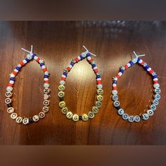 three bracelets made out of beads on top of a wooden table