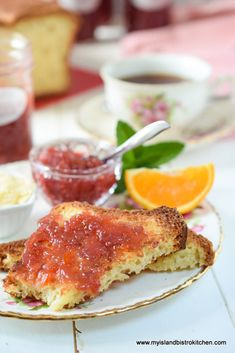 a close up of food on a plate with oranges and sauce in the background