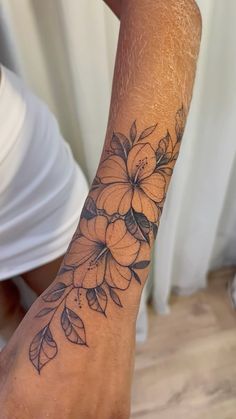 a person with a flower tattoo on their arm