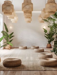 a room with wooden flooring and hanging lights above it is decorated with bamboo plants