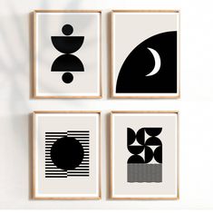 four black and white art prints hanging on a wall