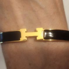 Black And Gold Slim H Bracelet. Stainless Steel Non Tarnishing Hypoallergenic Can Be Worn Daily. Bangles That Can Be Worn Separately Or Mixed With Others. Holiday Gift. 11/30 Elegant Black Bracelets For Everyday, Black Enamel Bracelets For Parties, Chic Black Bracelets For Formal Occasions, Elegant Bracelets With Black Band, Black Bangle Bracelet For Formal Occasions, Formal Black Bangle Bracelet, H Initial, H Bracelet, Daily Water