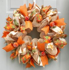 an orange and white wreath on the front door