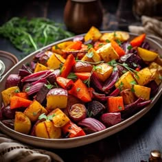 a bowl filled with roasted vegetables on top of a table