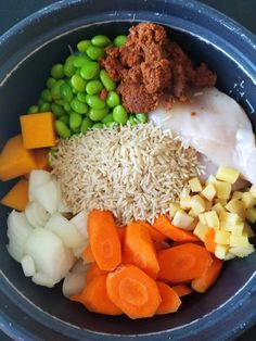 a bowl filled with rice, carrots, peas and other veggie ingredients