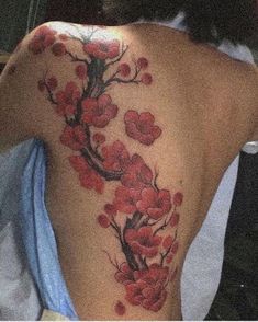 a woman with a cherry blossom tattoo on her back