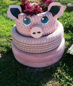 a planter made out of an old tire is sitting in the grass