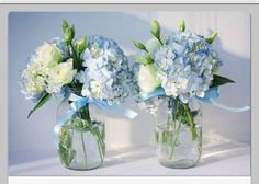 two vases with blue and white flowers in them