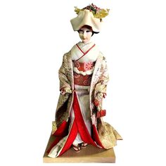 Beautifully crafted, large ornamented Japanese geisha doll in a finely decorative and layered flowing kimono. Very detailed, mid-1900s. Dimensions on stand: 24" High, 12" Wide, 9.5" Deep. Geisha Doll, Wood Display Stand, Disney Princess Movies, Slim Aarons, Japanese Geisha, Japanese Dolls, Gio Ponti, Wood Display, Keith Haring