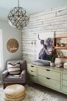 a living room with a couch, chair and painting on the wall