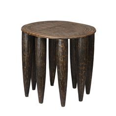 a wooden table with three legs and an intricate design on the top, made out of wood