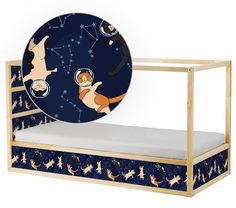 a wooden bed with a blue and gold design on the bottom, along with an animal plate