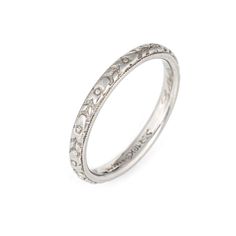 This is part of Chairish’s Fine Jewelry assortment.  Elegant vintage Art Deco era band (circa 1920s to 1930s) crafted in 18k white gold.   The ring epitomises vintage charm and would make a lovely wedding band. Also great worn alone or stacked with your jewellery from any era. The inner band is engraved "CMM to LGL 9 24 29"  The ring is in good condition. The embossed floral detail is in-tact with slight wear visible from normal wear.     Particulars:  Weight: 2.7 grammes  Stones:  N/A  Size & M Platinum White Gold Rings With Classic Design, Anniversary White Gold Bands Classic Design, Timeless White Gold Wedding Bands, Platinum White Gold Ring With Classic Design, Classic White Gold Platinum Rings, Timeless Wedding Ring With Decorative Band, Timeless Engraved Wedding Ring With Classic Design, Timeless Engraved Ring With Classic Design For Wedding, Timeless Classic Engraved Ring For Wedding