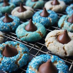 cookies with chocolate and sprinkles are cooling on a rack