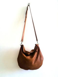 large brown leather bag .soft leatherThis bag is so comfortableand and versatile you can use it as a shoulder bag ,and cross body bag *   long adjustable strap attached*  Closed with metal zipper*  One zipper pocket inside*  2 open pocket inside*  Flat figure*  Italian leather* cotton liningApprox. dimensions: 14" x 16" incSee for more bags and purses here:http://www.etsy.com/shop/Smadars?ref=pr_shop_more**** A small surprise waiting for anyone who buys more than one item ***** Leather Gifts For Her, Brown Leather Crossbody Purse, Bag Packs, Cross Shoulder Bags, Brown Leather Backpack, Small Leather Bag, Laptop Shoulder Bag, Bags And Purses, Brown Leather Totes