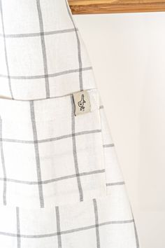 a white and black checkered dress with a button on it