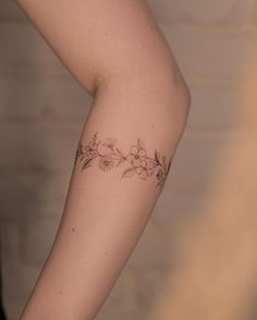 a woman with a flower tattoo on her arm