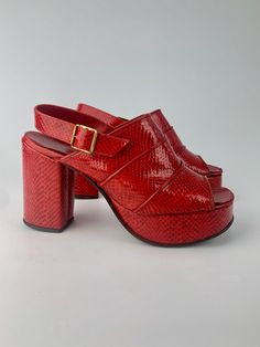 Rare & hard to find 1970'S Shinny Red Platform Shoes in faux lizard skin with open toes, side buckles and a slingback heel. The front of the platform is 1-3/8 inches tall and the heel is 4 inches tall These awesome platforms are in GOOD VINTAGE CONDITION.. with only light signs of wear There is no maker or size label attached. inside the platform reads: man made materials 270  2787 525019  368 By the inside sole measurements..  I would say this is a WOMEN'S SIZE 7 to 7-1/2 To be certain of the size, I would go by the inside measurements of a pair of shoes that fit you well & compare with these measurements: Inside measure of the sole: 9-1/2 inches from inside heel to the open toe x 3-1/8 inches wide at the ball of the foot 1970s Shoes Women, Red Platform Shoes, 1970s Shoes, Red Platform, Chic Shoes, 4 Inch Heels, Slingback Heel, Shoes Trainers, Platform Shoes