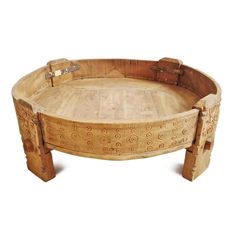 a round wooden table with carvings on it