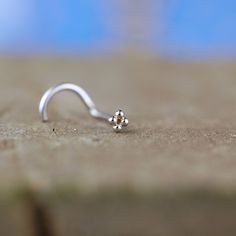 Tiny Sterling Silver Nose Stud Searching for a breakaway from the plain ball, but still needing something dainty? Look no further than this nose stud. Demure and elegant in nickel free sterling silver, this stud is tiny and flat to the nose, giving you the perfect classy look you seek.• 2mm wide x 2mm wide (about .078")• handcrafted in my home studio in sterling silver• nickel free How To Choose Your Nose Stud Gauge and End Style What is the nose jewelry gauge? Gauge is the thickness of the part Silver Nose Stud, Nose Pin, Nose Jewelry, Nose Art, The Nose, Nose Ring Stud, Nose Stud, Simple Jewelry, How To Look Classy