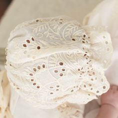 Handmade in the USA The Ingrid Lace Bonnet is a beautiful compliment to our Ingrid Christening Gown! Crafted with a 100% cotton lace in light ivory and a natural champagne tone. This lovely material has a vintage look we love! The back of the bonnet buttons for a unique detail. Designed to create sweet lace ruffles that frame her face. Champagne cotton ribbons ties complete the design. 100% cotton 100% cotton ribbon ties Shell button back Fitted Embroidered Cream Lace, Fitted Cream Embroidered Lace, Cream Embroidered Fitted Lace, White Crochet Lace In Feminine Style, White Crochet Lace With Feminine Style, Spring Cotton Lace With Lace Work, Cream Crochet Lace For Spring, Beige Crochet Lace For Summer, Spring Cream Crochet Lace