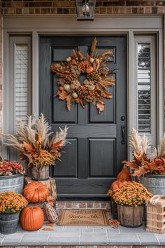 a front porch with fall decorations and pumpkins