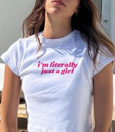 "𝑰'𝒎 𝒍𝒊𝒕𝒆𝒓𝒂𝒍𝒍𝒚 𝒋𝒖𝒔𝒕 𝒂 𝒈𝒊𝒓𝒍" Soft Tee Make a fashion statement with our trendy tee. I'm (literally) just a girl. At 𝑴𝒚𝑺𝒉𝒊𝒓𝒕𝑺𝒂𝒊𝒅𝑺𝒐, our mission is to inspire love and boost confidence with every shirt we create. 𝑷𝒓𝒐𝒅𝒖𝒄𝒕 𝑫𝒆𝒕𝒂𝒊𝒍𝒔: * 100% cotton * Semi-fitted * Runs true to standard size * Gildan 64000L → Pro Tip: size down for that extra cropped baby tee fit! 𝑪𝒂𝒓𝒆 𝑰𝒏𝒕𝒓𝒖𝒄𝒕𝒊𝒐𝒏𝒔: * Cold machine wash with like colours * Do not bleach * Do not Pink Tops With Funny Text For Spring, Trendy Slogan Tops, Trendy Slogan T-shirt For Spring, Trendy Spring Slogan T-shirt, Y2k Style Text Print T-shirt For Spring, Trendy Spring Tops With Letter Print, Y2k Tops With Funny Text For Summer, Y2k Summer Top With Funny Text, Y2k Summer Tops With Funny Text