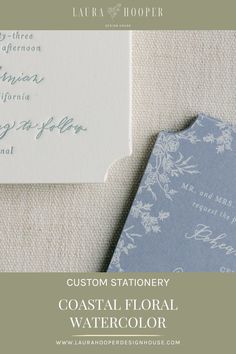 the wedding stationery is shown with blue and white flowers