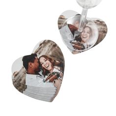 two heart shaped magnets with an image of a couple holding each other