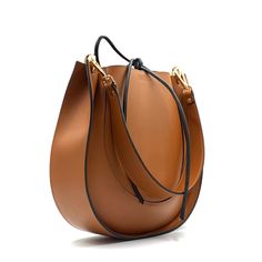 Introducing an original leather bag. With its sleek design and large size, it fits all your essentials. Inside, there"s one large compartment.  Made of high-quality italian leather. Close with leather ties.  Size: 29x28x8 cm (11,4x11x3,15 inches)  Belt Length: 60cm (23,6 inch) Hardware is gold.  If your like this bag, but want nodifications, please let me know. I can customize the size or color for you. Feel free to ask any questions. Cognac Calf Leather Shoulder Bag For Daily Use, Daily Use Cognac Calf Leather Shoulder Bag, Leather Bucket Bag With Smooth Grain For Office, Calf Leather Bags In Cognac For Everyday Use, Cognac Leather Bucket Bag For Work, Leather Hobo Bag With Leather Handles For Office, Cognac Smooth Grain Saddle Bag For Everyday Use, Everyday Cognac Calf Leather Shoulder Bag, Everyday Cognac Saddle Bag With Smooth Grain