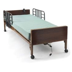 an empty hospital bed with wheels and rails