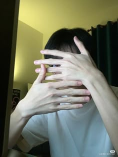 a woman covering her face with both hands