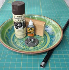 the supplies needed to make an acrylic paint job are on a green cutting board