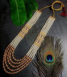 RAADHE CREATION's First time ever MONALISA pearl Multiple layers beaded long necklace from RAADHE CREATION is best pick for groom. The metal crafted Brass studded with sparkling stones and Pearl made from golden finish metal. It is woven with MONALISA pearl beads and comes with adjustable dori. So that it could be adjusted properly with your wedding sherwani. Brides are upping their game as it is, but grooms are no less too! Here are some Premium groom necklaces which spotted some unique accesso Wedding Beaded Necklace With Latkans For Diwali, White Temple Jewelry Beaded Necklaces For Wedding, White Temple Jewelry Beaded Necklace For Wedding, White Beaded Temple Necklace For Festive Occasions, White Beaded Bridal Necklace For Diwali, White Long Beaded Necklace For Wedding, Festive White Beaded Temple Necklace, Traditional Pearl Chain Beads For Festive Occasion, Traditional Gold Beaded Necklaces For Wedding