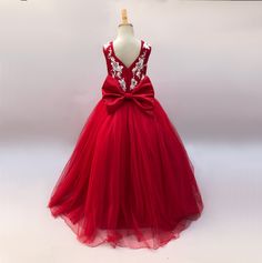 Add a touch of sophistication and elegance to your little girl's wardrobe with this stunning red ball gown. Adorned with delicate ivory shimmer floral lace embellishments, this dress is perfect for special occasions and elegant events. Make her feel like a princess in this beautifully crafted gown that will surely turn heads and create lasting memories. A truly exquisite addition to her wardrobe that she will cherish for years to come. Size Guide: 1) All our Gowns can be made in any size ranging from Kids 2T to Adult Plus Sizes. 2) Ordering based on Size Chart: Before you place your order please compare your measurements to the size chart provided. 3) Ordering Custom: If you choose to submit custom measurements, we will be adding an inch to the chest and waist circumference to allow room f Sleeveless Tulle Pageant Dress With Fitted Bodice, Red Gown For Pageant During Prom Season, Princess Style Lace Ball Gown, Princess Style Lace Floor-length Ball Gown, Pageant Dress With Floral Applique And Fitted Bodice, Princess Style Floor-length Lace Dress, Floral Applique Ball Gown For Prom Season, Elegant Ball Gown With Floral Appliqué And Sweetheart Neckline, Elegant Ball Gown With Floral Applique And Sweetheart Neckline