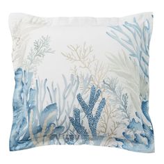 an ocean themed pillow with blue corals and seaweed on the front, white background