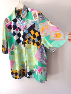 Vintage Women's Colorful Tarot Cards Print Shirt/Blouse Size: S. Material: 100% Viscose. Abstract Print, Tarot Cards Print, Queen, Jack, Crazy Print, Rounds, Plaid Print. Bright Colors: pink, green, white, black, blue, yellow. Short sleeve. Buttons Closure. Collared. Measurements: latying flat and doubled where necessary. armpit to armpit: 56 cm (22.04") length from shoulder to hem: 71 cm (27.95")  sleeve length: 32 cm (12.59") shoulder to shoulder: 43 cm (16.93") Very good vintage condition. Li Green Short Sleeve Blouse With Patchwork, Green Collared Blouse With Graphic Print, Green Graphic Print Short Sleeve Blouse, Green Short Sleeve Blouse With Graphic Print, Green Blouse With Graphic Print And Short Sleeves, Retro Green Printed Blouse, Green Patchwork Short Sleeve Shirt, Retro Green Blouse With Graphic Print, Green Retro Patchwork Tops